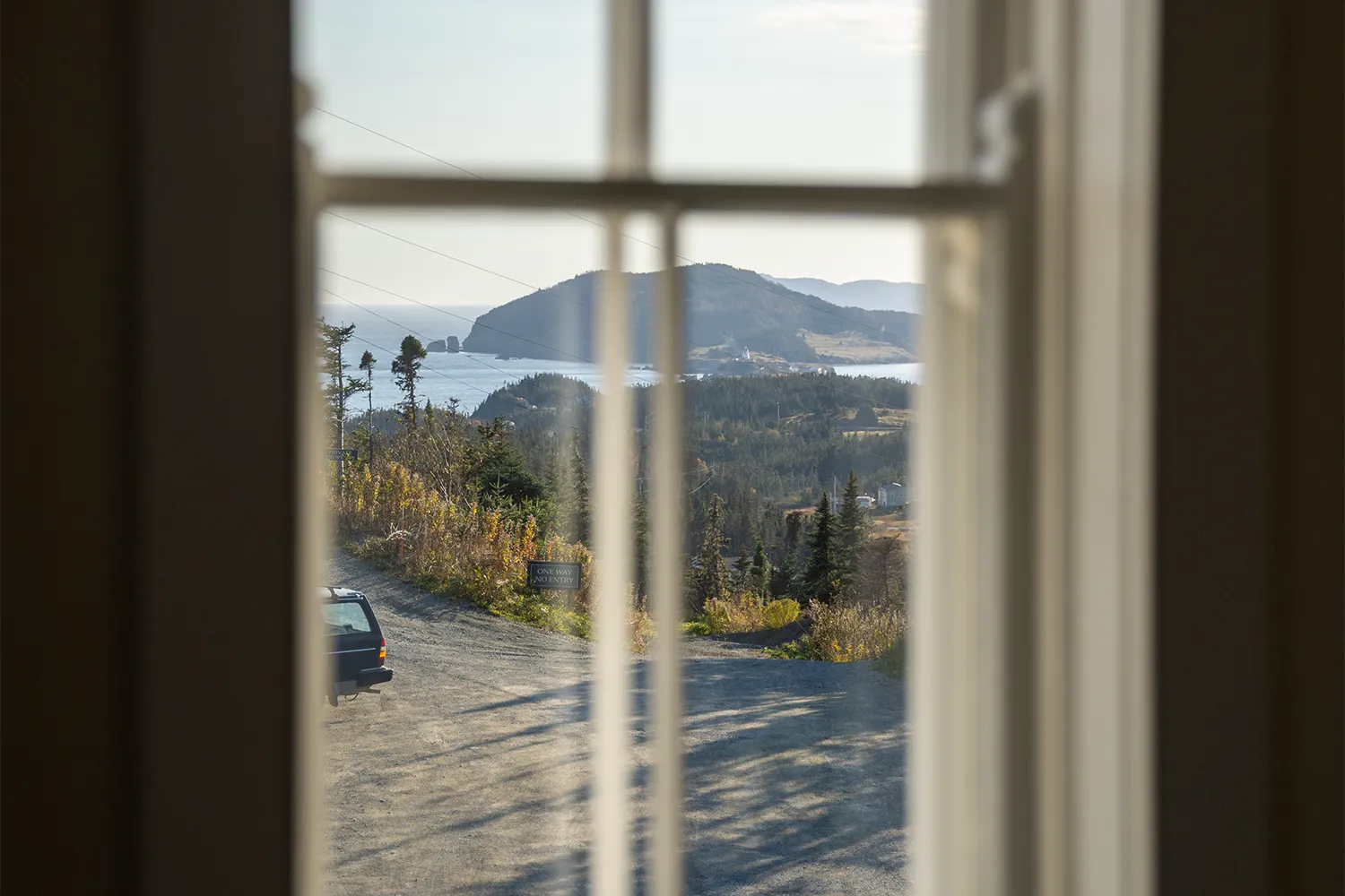 Coastal view through a window at Fisher's Loft, Port Rexton, Newfoundland