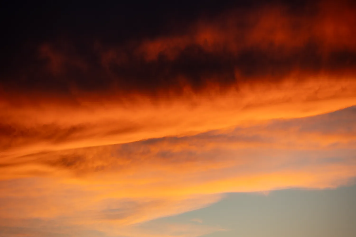 Vibrant orange sunset clouds over Tors Cove and Witless Bay, Newfoundland